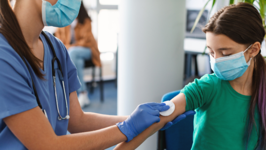 A preteen being administered the HPV vaccine.